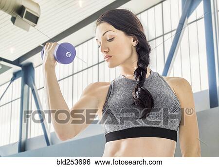 Caucasian woman lifting weights View Large Photo Image Stock Photograph - Caucasian woman lifting weights. Fotosearch