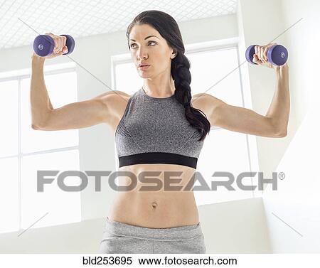 Stock Photography - Caucasian woman lifting weights. Fotosearch