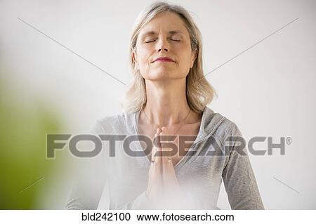 Caucasian woman meditating View Large Photo Image Stock Image - Caucasian woman meditating. Fotosearch