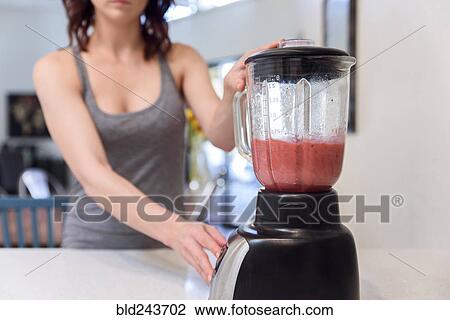 Caucasian woman mixing fruit smoothie in blender View Large Photo Image Stock Image - Caucasian woman mixing fruit smoothie in blender. Fotosearch