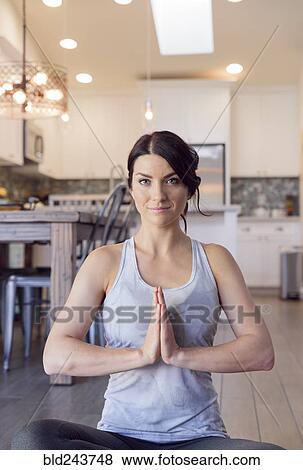 Stock Photo - Caucasian woman performing yoga and meditating. Fotosearch