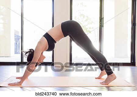 Stock Image - Caucasian woman performing yoga. Fotosearch