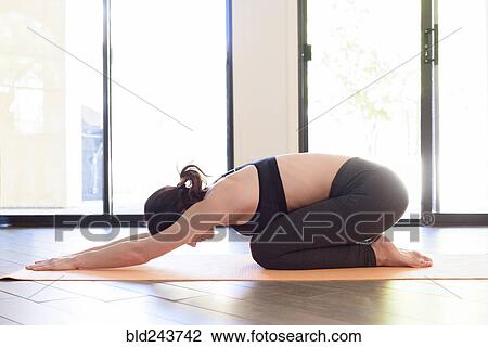 Stock Image - Caucasian woman performing yoga. Fotosearch