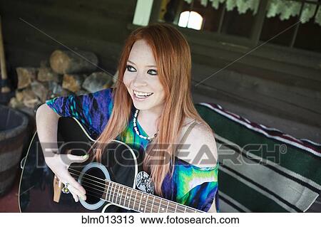 Caucasian woman playing guitar View Large Photo Image Stock Image - Caucasian woman playing guitar. Fotosearch