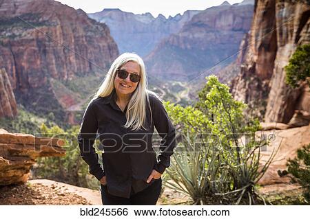 Caucasian woman posing near rock formations View Large Photo Image Stock Photograph - Caucasian woman posing near rock formations. Fotosearch