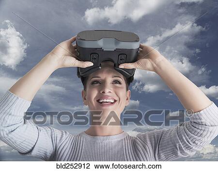 Caucasian woman removing virtual reality goggles View Large Photo Image Stock Image - Caucasian woman removing virtual reality goggles. Fotosearch