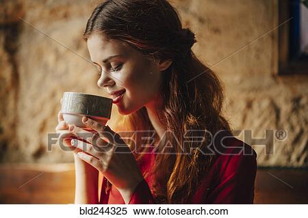 Stock Photography - Caucasian woman sipping cup of tea. Fotosearch