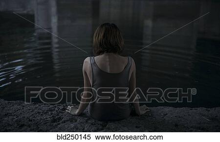 Caucasian woman sitting at edge of water View Large Photo Image Stock Photography - Caucasian woman sitting at edge of water. Fotosearch