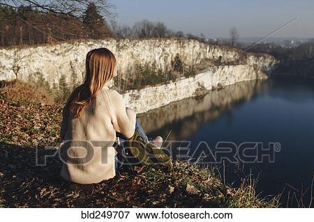 Caucasian woman sitting at the edge of reservoir View Large Photo Image Stock Photo - Caucasian woman sitting at the edge of reservoir. Fotosearch
