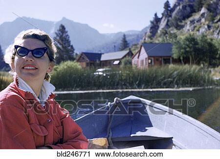 Caucasian woman sitting in boat on lake View Large Photo Image Stock Image - Caucasian woman sitting in boat on lake. Fotosearch