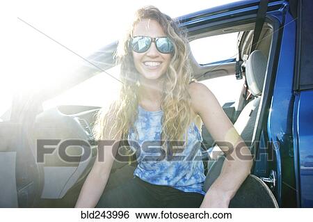Caucasian woman sitting in car with skateboard View Large Photo Image Stock Photograph - Caucasian woman sitting in car with skateboard. Fotosearch