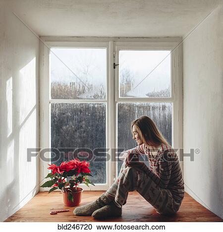 Caucasian woman sitting in window sill drinking coffee in pajamas View Large Photo Image Stock Image - Caucasian woman sitting in window sill drinking coffee in pajamas. Fotosearch
