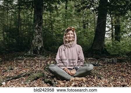 Caucasian woman sitting in with autumn leaves in hood View Large Photo Image Stock Photo - Caucasian woman sitting in with autumn leaves in hood. Fotosearch