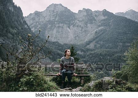 Caucasian woman sitting on bench in mountains View Large Photo Image Stock Image - Caucasian woman sitting on bench in mountains. Fotosearch