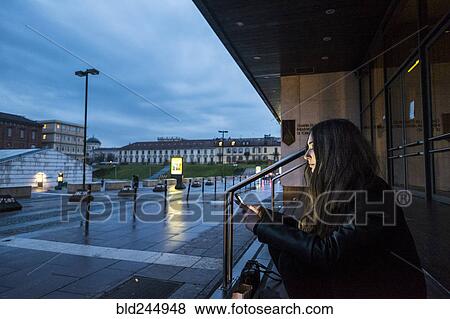 Caucasian woman sitting on staircase outdoors texting on cell phone View Large Photo Image Stock Photo - Caucasian woman sitting on staircase outdoors texting on cell phone. Fotosearch