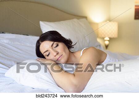 Caucasian woman sleeping on bed View Large Photo Image Picture - Caucasian woman sleeping on bed. Fotosearch