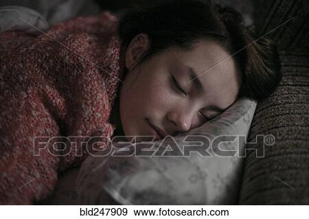 Stock Photo - Caucasian woman sleeping on pillow. Fotosearch