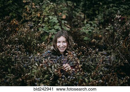 Caucasian woman smiling in bush View Large Photo Image Stock Image - Caucasian woman smiling in bush. Fotosearch