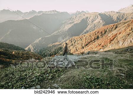 Caucasian woman smiling on mountain overlooking valley View Large Photo Image Stock Photograph - Caucasian woman smiling on mountain overlooking valley. Fotosearch