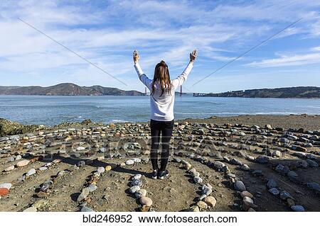 Caucasian woman standing in circle of rocks near ocean View Large Photo Image Stock Image - Caucasian woman standing in circle of rocks near ocean. Fotosearch