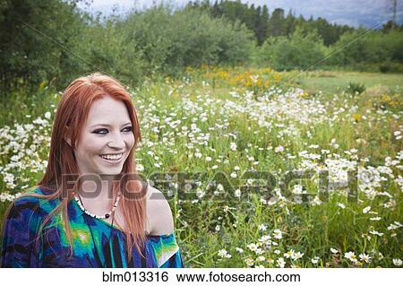 Caucasian woman standing in field View Large Photo Image Stock Photograph - Caucasian woman standing in field. Fotosearch