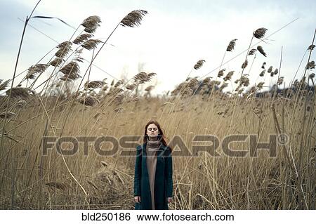 Caucasian woman standing in field with eyes closed View Large Photo Image Stock Photograph - Caucasian woman standing in field with eyes closed. Fotosearch