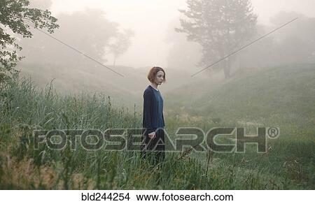 Caucasian woman standing in fog on hillside View Large Photo Image Picture - Caucasian woman standing in fog on hillside. Fotosearch