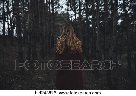 Stock Photograph - Caucasian woman standing in forest. Fotosearch