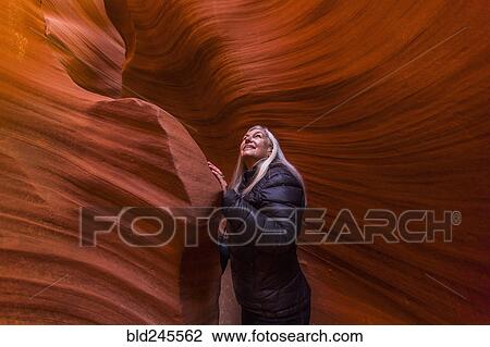 Stock Image - Caucasian woman standing in rock formation. Fotosearch