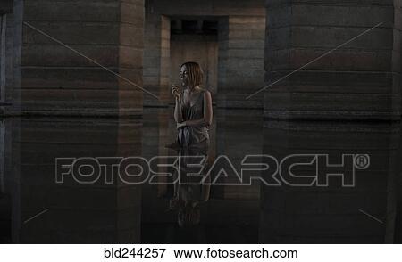 Caucasian woman standing in water smoking cigarette View Large Photo Image Stock Photo - Caucasian woman standing in water smoking cigarette. Fotosearch