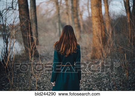 Caucasian woman standing near trees and river View Large Photo Image Stock Image - Caucasian woman standing near trees and river. Fotosearch