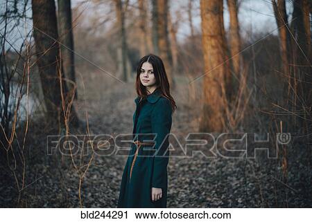 Caucasian woman standing near trees and river View Large Photo Image Stock Image - Caucasian woman standing near trees and river. Fotosearch