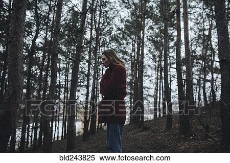 Caucasian woman standing near trees View Large Photo Image Stock Photography - Caucasian woman standing near trees. Fotosearch