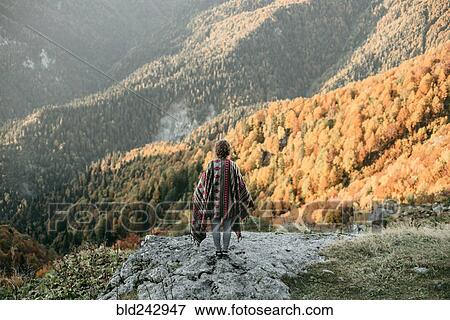 Caucasian woman standing on mountain overlooking valley View Large Photo Image Stock Photo - Caucasian woman standing on mountain overlooking valley. Fotosearch