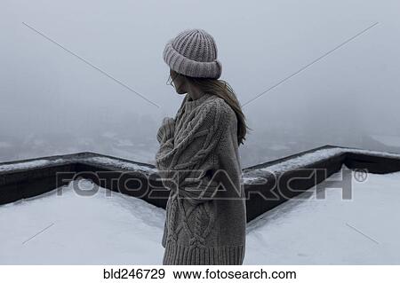 Caucasian woman standing on rooftop in winter View Large Photo Image Stock Photo - Caucasian woman standing on rooftop in winter. Fotosearch
