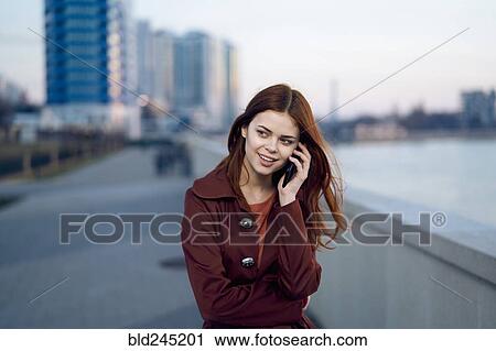 Caucasian woman talking on cell phone at waterfront View Large Photo Image Stock Image - Caucasian woman talking on cell phone at waterfront. Fotosearch