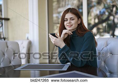 Caucasian woman texting on cell phone at restaurant View Large Photo Image Stock Photography - Caucasian woman texting on cell phone at restaurant. Fotosearch
