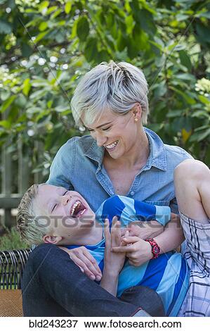 Caucasian woman tickling son outdoors View Large Photo Image Stock Photo - Caucasian woman tickling son outdoors. Fotosearch