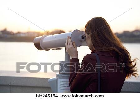 Caucasian woman using binoculars at waterfront View Large Photo Image Picture - Caucasian woman using binoculars at waterfront. Fotosearch
