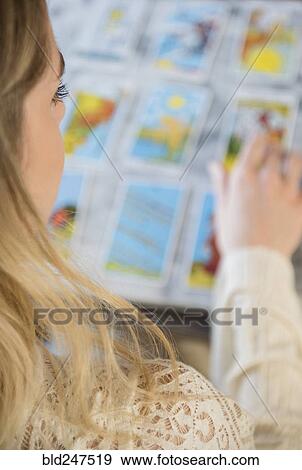Caucasian woman using tarot cards View Large Photo Image Stock Photo - Caucasian woman using tarot cards. Fotosearch