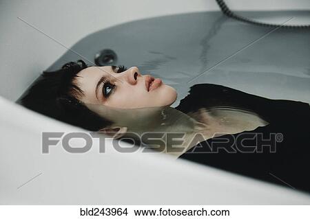Caucasian woman wearing dress in bathtub View Large Photo Image Picture - Caucasian woman wearing dress in bathtub. Fotosearch