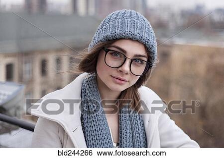 Stock Photograph - Caucasian woman wearing eyeglasses with scarf and hat. Fotosearch