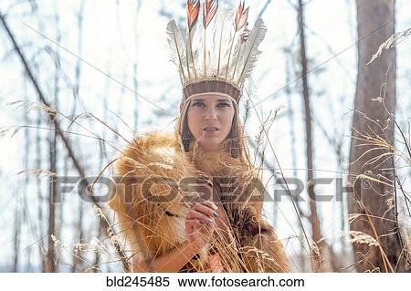 Stock Photography - Caucasian woman wearing headdress in forest. Fotosearch
