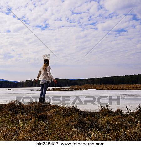 Caucasian woman wearing headdress near river View Large Photo Image Stock Image - Caucasian woman wearing headdress near river. Fotosearch