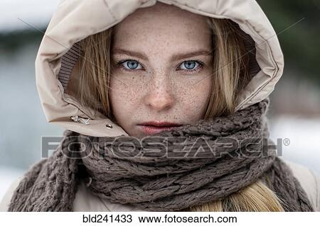 Stock Image - Caucasian woman wearing hood and scarf. Fotosearch