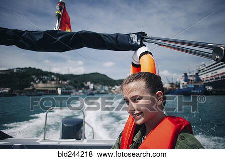 Caucasian woman wearing life-jacket in speedboat View Large Photo Image Stock Photo - Caucasian woman wearing life-jacket in speedboat. Fotosearch