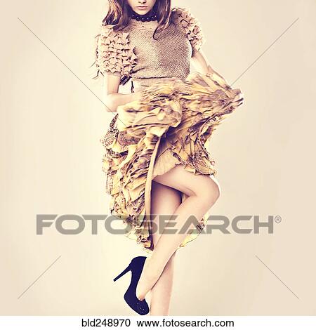 Caucasian woman wearing ruffled skirt standing on one leg View Large Photo Image Stock Image - Caucasian woman wearing ruffled skirt standing on one leg. Fotosearch