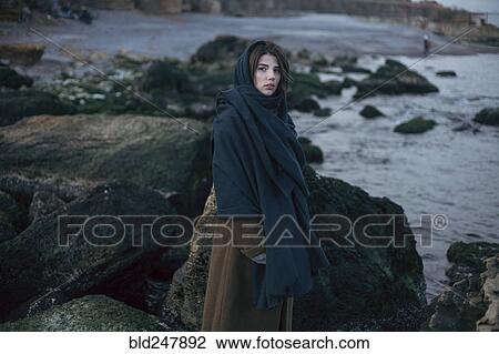 Caucasian woman wearing scarf near rocks at ocean View Large Photo Image Stock Image - Caucasian woman wearing scarf near rocks at ocean. Fotosearch