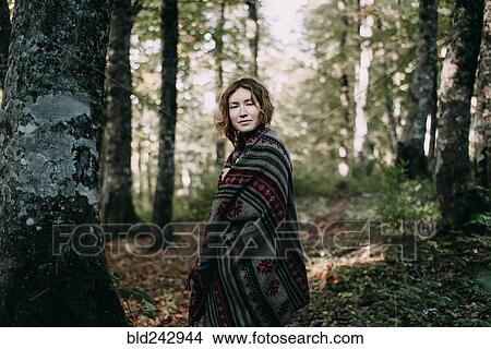 Picture - Caucasian woman wearing shawl in forest. Fotosearch