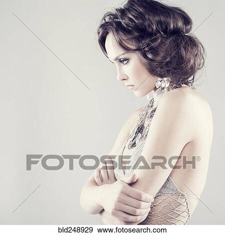 Stock Photo - Caucasian woman with attitude wearing sheer dress looking away. Fotosearch